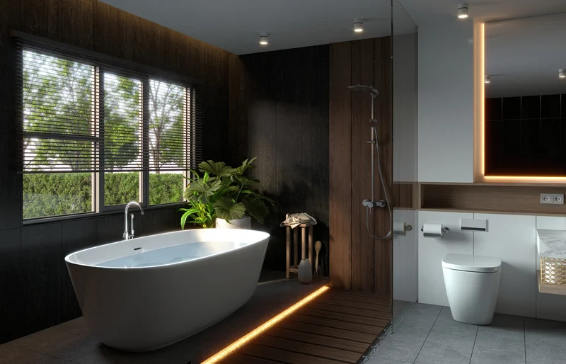Modern dark bathroom design with freestanding tub and ambient LED strip light. Modern dark bathroom design with freestanding tub and ambient LED strip light.